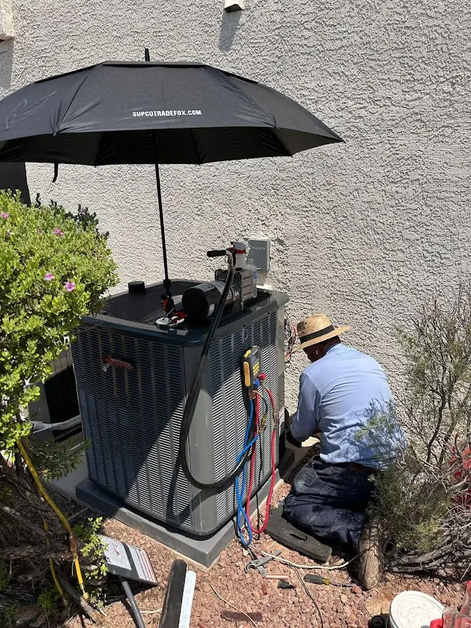 HVAC technician performing outdoor AC maintenance in Little Egg Harbor
